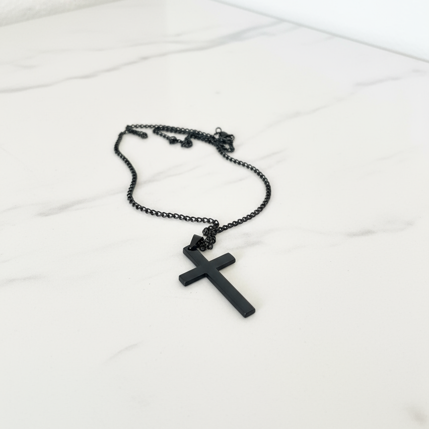 Black Cross Necklace on White Counter